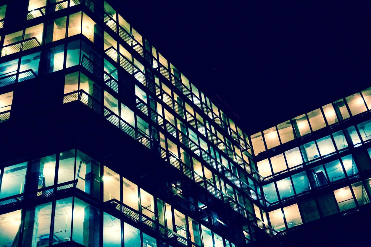 A building with many windows lit up at night.