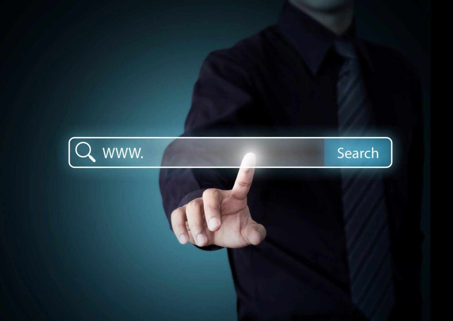 A man in black shirt and tie pointing to the search bar.
